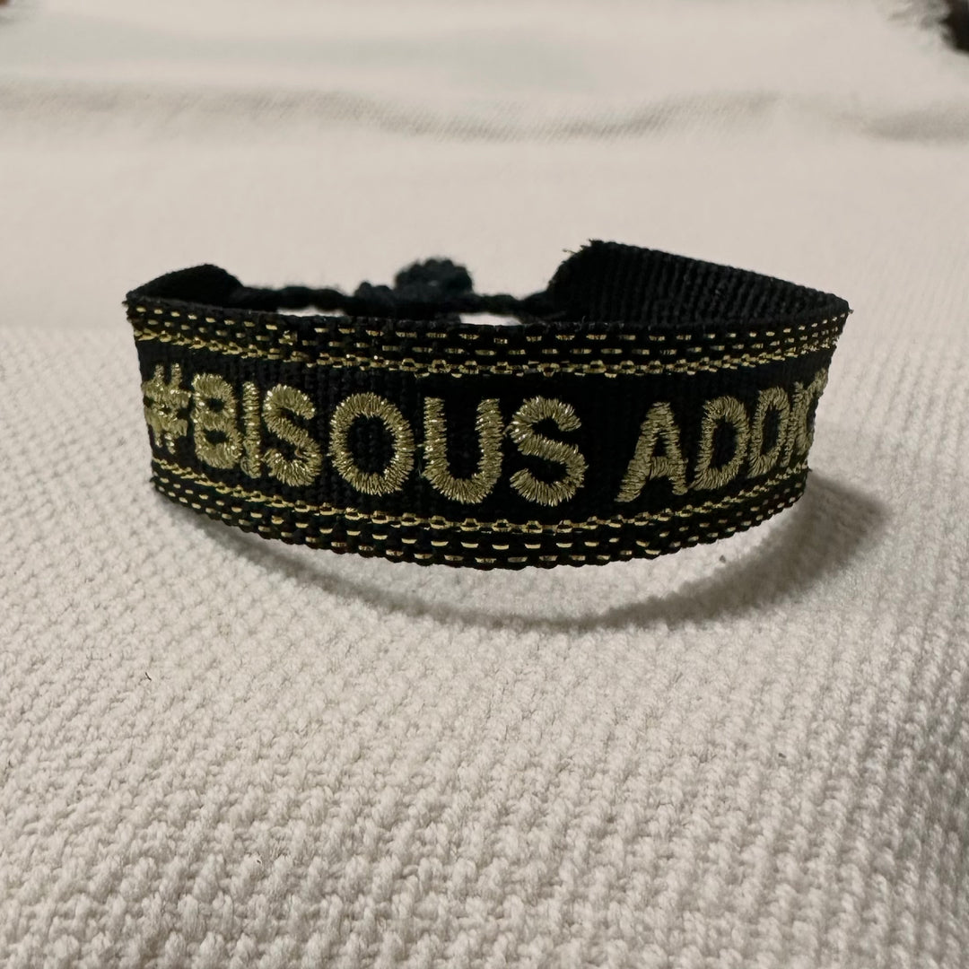 Black woven bracelet with gold thread embroidery, bisous addict