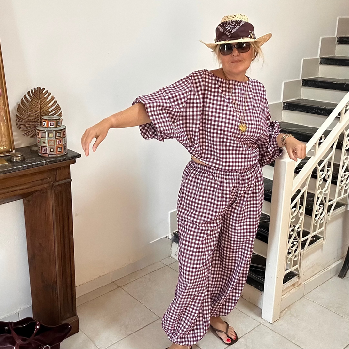 Woman wearing aubergine gingham cotton set with oversized blouse and wide-leg pants – La Maison Angélique