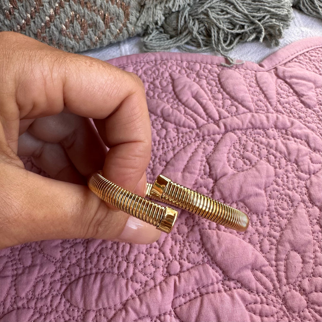 MILA-JO waterproof gold open cuff bracelet held in hand