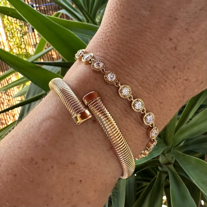 MILA-JO gold open cuff stacked with gold tennis bracelet