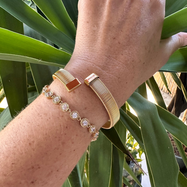 MILA gold open cuff stacked with gold tennis bracelet