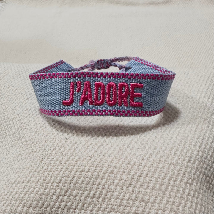 Sky blue woven cotton bracelet with pink French embroidery and dotted border